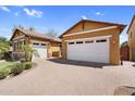 A charming, Southwestern style home with a brick driveway and multiple garage spaces for plenty of storage at 19291 E Thornton Rd, Queen Creek, AZ 85142