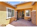 Inviting front porch with stylish brickwork, decorative plants, and a welcoming entryway at 19291 E Thornton Rd, Queen Creek, AZ 85142