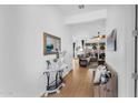 Bright hallway with wood floors leads to a spacious living area and showcases stylish home decor at 19291 E Thornton Rd, Queen Creek, AZ 85142