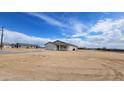 A new single-story home with an attached garage and desert landscape, part of a developing residential community at 20435 W Mountain Sage Dr, Buckeye, AZ 85326