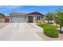 Single-story home featuring a two car garage and neatly landscaped front yard at 22262 E Cherrywood Ct, Queen Creek, AZ 85142
