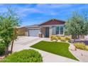 Charming single-story home with a well-maintained front yard featuring green grass and a decorative walkway at 22262 E Cherrywood Ct, Queen Creek, AZ 85142