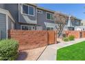 Charming two-story home with a brick wall, wooden gate and freshly manicured lawn at 2301 E University Dr # 233, Mesa, AZ 85213