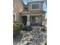 Inviting front porch with desert landscaping, rocks and flowering bushes at 2411 W Lucia Dr, Phoenix, AZ 85085