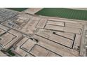 Development with streets cut and homes under construction on large lots, promising a spacious and modern community at 24232 W Agora Ln, Buckeye, AZ 85326