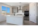 Bright kitchen features quartz counters, stainless steel appliances, and modern gray cabinets at 24232 W Agora Ln, Buckeye, AZ 85326