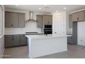 Bright kitchen features quartz counters, stainless steel appliances, and modern gray cabinets at 24232 W Agora Ln, Buckeye, AZ 85326