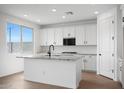 Bright kitchen with white cabinets, granite counters, stainless appliances, island with sink, and tile backsplash at 24249 W Agora Ln, Buckeye, AZ 85326
