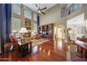 Spacious living area with hardwood floors, fireplace, large windows and custom built in shelves at 2726 S 160Th Ave, Goodyear, AZ 85338