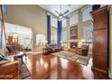 Bright living room showcasing soaring ceilings, a fireplace, and hardwood floors at 2726 S 160Th Ave, Goodyear, AZ 85338