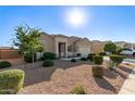 Beautiful single-story home with desert landscaping, mature trees, and a convenient two-car garage at 30089 W Rockmount Ave, Buckeye, AZ 85396