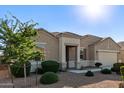 Attractive single-story home boasting desert landscaping, a quaint front porch, and a two-car garage at 30089 W Rockmount Ave, Buckeye, AZ 85396
