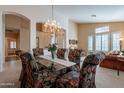 Elegant dining room featuring a chandelier and seating for six with glass table at 31017 N 41St Pl, Cave Creek, AZ 85331