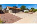 Home featuring desert landscaping, a two-car garage and a basketball hoop at 4316 E Janice Way, Phoenix, AZ 85032