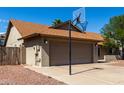 Side angle view of the two-car garage and basketball hoop at 4316 E Janice Way, Phoenix, AZ 85032