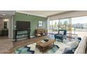 Bright living room with large windows showcasing a view and stylish, comfortable furniture at 4750 N Central Ave # G3, Phoenix, AZ 85012