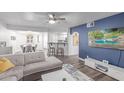 Stylish living room featuring hardwood floors, a modern ceiling fan, and an inviting open-concept design at 5104 N 32Nd St # 144, Phoenix, AZ 85018