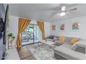 Bright living room with a sliding glass door to the patio and modern decor, perfect for relaxing and entertaining at 5104 N 32Nd St # 144, Phoenix, AZ 85018