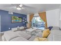 Comfortable living room featuring a sliding glass door that leads to the patio, complete with trendy decor at 5104 N 32Nd St # 144, Phoenix, AZ 85018