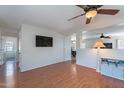 Comfortable living room with hardwood floors, TV, and an open floor plan at 5305 E Silverbell Rd, San Tan Valley, AZ 85143