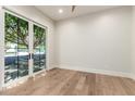 Bright bedroom with wood floors and large glass doors to the backyard with a seating area at 5440 E Calle Camelia --, Phoenix, AZ 85018