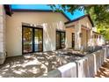 Beautiful backyard patio featuring a modern fire pit and large windows overlooking a landscaped yard at 5440 E Calle Camelia --, Phoenix, AZ 85018