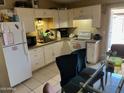 Cozy kitchen with white cabinets, updated appliances, and a dining area at 6711 W Osborn Rd # 138, Phoenix, AZ 85033