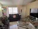 Comfortable living room with tile floors, neutral paint, and stylish furniture at 6711 W Osborn Rd # 138, Phoenix, AZ 85033