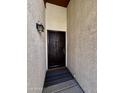 Inviting front entryway with a security door, exterior light fixture and textured walls at 6845 W Caron Dr, Peoria, AZ 85345