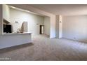 Bright living space featuring neutral carpet, natural light, and an open floor plan at 6845 W Caron Dr, Peoria, AZ 85345