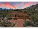 Stunning exterior elevation showing the desert landscaping and 3 car garage at 7728 E Mary Sharon Dr, Scottsdale, AZ 85266