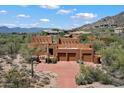 Exterior showcasing desert landscaping, driveway and a three car garage at 7728 E Mary Sharon Dr, Scottsdale, AZ 85266