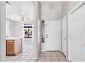 Inviting entryway showcasing light tile flooring, a white front door, and an open view to the living area at 8802 E University Dr # 28, Mesa, AZ 85207