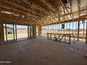 Framing of open-concept living area with patio doors and framed bar area, ready for customization and finishing touches at 9532 W Parkway Dr, Tolleson, AZ 85353