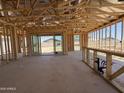 Framing of open-concept living area with patio doors and framed bar area, ready for customization and finishing touches at 9532 W Parkway Dr, Tolleson, AZ 85353