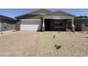 New single-story home features a two-car garage and welcoming front porch at 9544 W Parkway Dr, Tolleson, AZ 85353