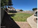 Large backyard with a well-maintained lawn and rock landscaping at 970 W Leah Ln, Gilbert, AZ 85233