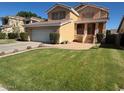 Traditional home with a well-maintained lawn, desert landscaping, and a two-car garage at 970 W Leah Ln, Gilbert, AZ 85233