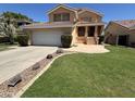 Charming two-story home with a well-manicured lawn, tile roof, and inviting front porch at 970 W Leah Ln, Gilbert, AZ 85233