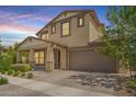 Inviting two-story home with a covered porch, a two-car garage, and well-maintained landscaping at 10221 E Wavelength Ave, Mesa, AZ 85212