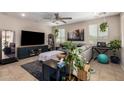 Cozy living room with a large sectional sofa, a modern entertainment center, and ample natural light at 10221 E Wavelength Ave, Mesa, AZ 85212