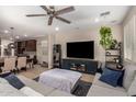 Open-concept living space with comfortable seating, a large television, and seamless flow to the dining area at 10221 E Wavelength Ave, Mesa, AZ 85212
