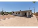 Charming single-story home with desert landscaping, carport, and cozy front porch at 126 N 58Th St, Mesa, AZ 85205