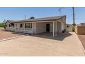 Charming single-story home with desert landscaping, carport, and cozy front porch at 126 N 58Th St, Mesa, AZ 85205