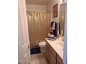 Cozy bathroom featuring vanity sink, and gold shower curtain at 12955 E Sahuaro Dr, Scottsdale, AZ 85259