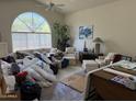Bright living room featuring vaulted ceilings and a large arched window allowing natural light at 12955 E Sahuaro Dr, Scottsdale, AZ 85259