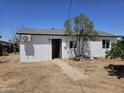 Rear exterior of a newly renovated home with a modern design and fresh landscaping at 15445 N Verde St, Surprise, AZ 85378