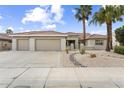 Attractive single-story home with three-car garage, desert landscaping, and a neutral color palette at 15501 W Camino Real Way, Surprise, AZ 85374