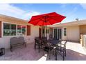 Outdoor patio seating area with a large umbrella, perfect for enjoying sunny days with comfortable furniture at 15614 N Lakeforest Dr, Sun City, AZ 85351