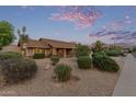 Inviting home with desert landscaping, mature bushes, and charming brick accents at 15849 N 46Th Pl, Phoenix, AZ 85032